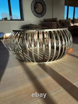 Round stainless steel and glass coffee table