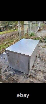 Used commercial stainless steel table and storage cabinet